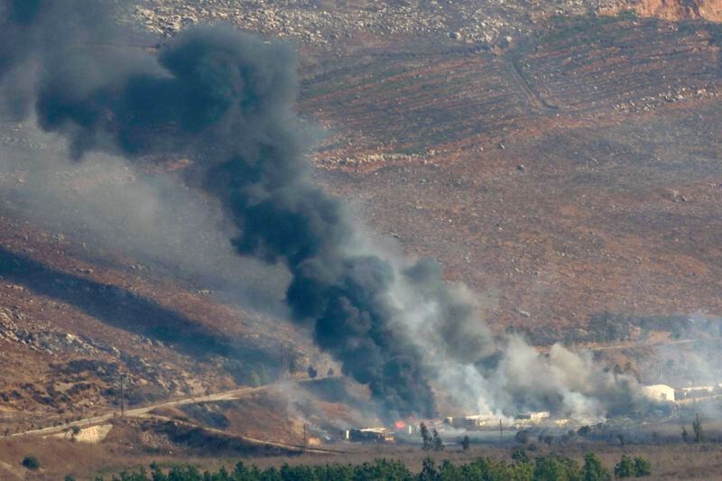 Flame and smoke rise from an Israeli airstrike in the Khiam valley, as seen from Marjayoun town, south Lebanon, Tuesday, Sept. 24, 2024. (AP Photo/Hussein Malla)