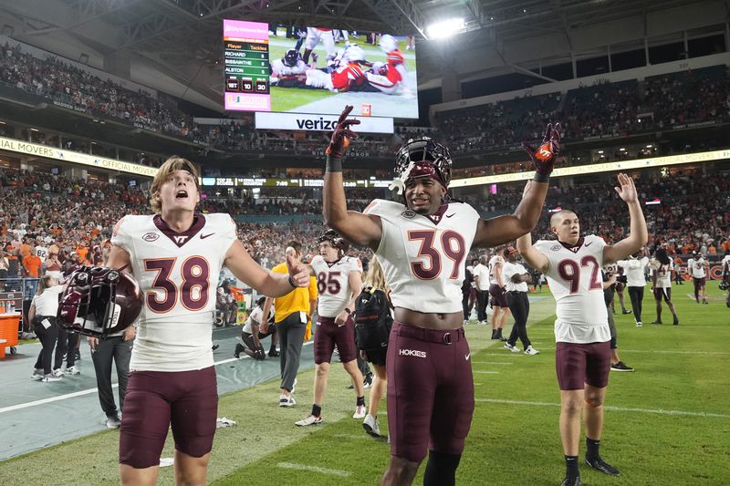 Virginia Tech players gesture after an official makes a decision on a last minute play during the second half of an NCAA college football game against Miami, Friday, Sept. 27, 2024, in Miami Gardens, Fla. (AP Photo/Marta Lavandier)