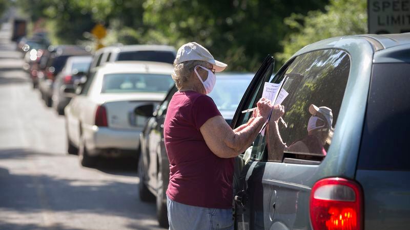 SUMMERTOWN, GA - JULY 14, 2020: Jeanne Coleman of the Summertown Food Pantry counts the number of people needing food during the mobile food drive at the Summertown Baptist Church. Food insecurity was already worse in rural Georgia before the pandemic began. The virus has only exacerbated those disparities and increased concerns that families are now facing hunger. (AJC Photo/Stephen B. Morton)