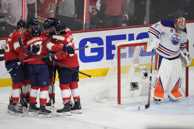 Florida Panthers teammates celebrate with Carter Verhaeghe (23) after he scored a goal during the first period of Game 7 of the NHL hockey Stanley Cup Final against the Edmonton Oilers, Monday, June 24, 2024, in Sunrise, Fla. (AP Photo/Rebecca Blackwell)