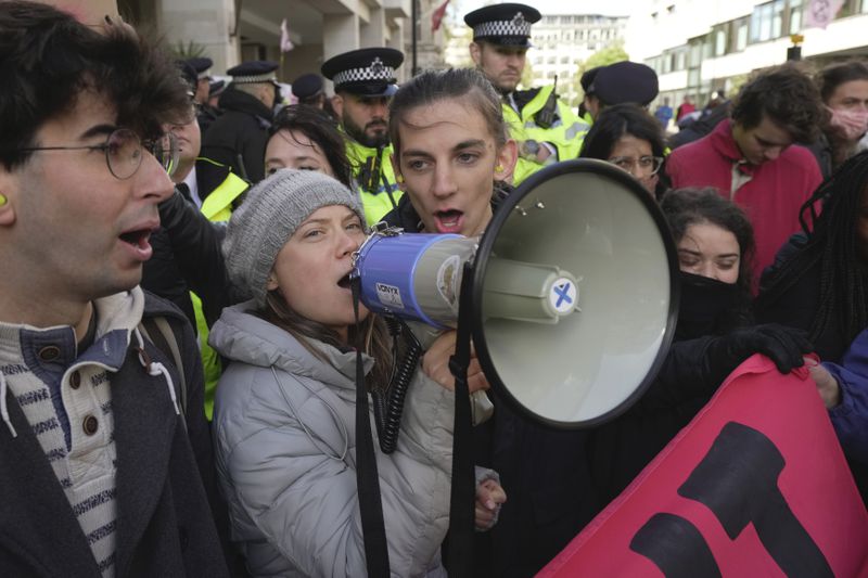 FILE - Environmental activist Greta Thunberg shouts slogans during the Oily Money Out protest outside the Intercontinental Hotel, in London, Oct. 17, 2023. (AP Photo/Kin Cheung, File)