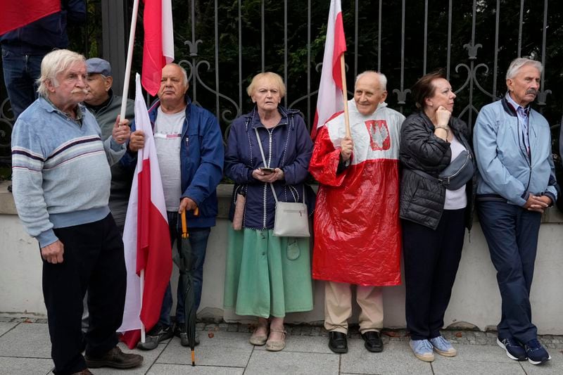 Backers of the right-wing opposition party Law and Justice take part in a protest ally of a few thousand people against the policies of Prime Minister Donald Tusk's Cabinet before the Ministry of Justice, in Warsaw, Poland, Saturday Sept. 14, 2024. (AP Photo/Czarek Sokolowski)