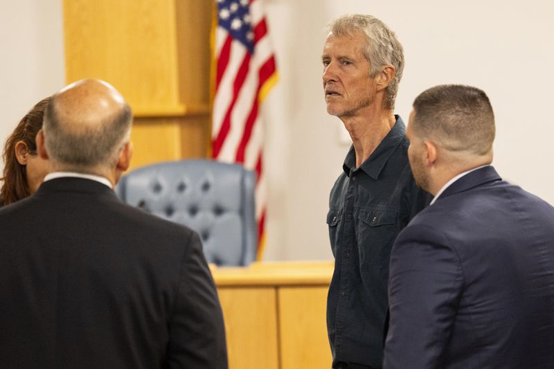 Tym Catterson, second from right, a contractor for OceanGate, talks to family members from the Titan tragedy after his testimony ended in a Coast Guard investigatory hearing on the causes of the implosion of an experimental submersible headed for the wreck of the Titanic, Monday, Sept. 16, 2024, in North Charleston, S.C. (AP Photo/Mic Smith)