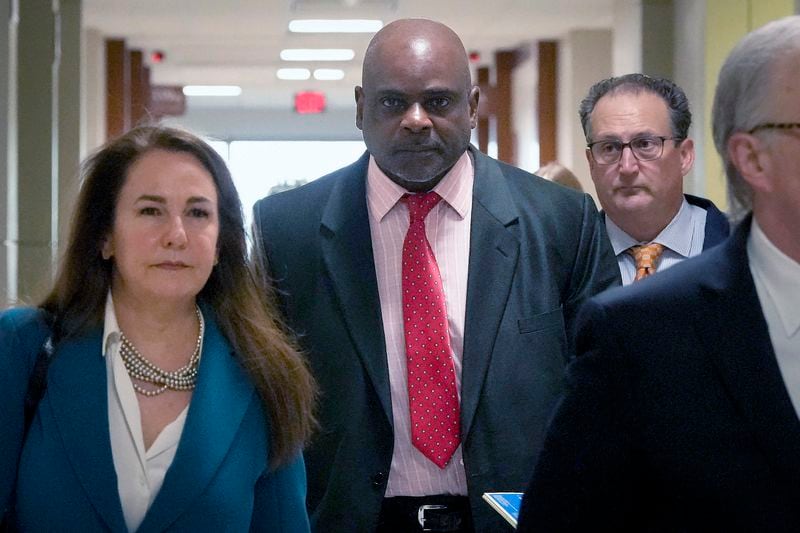 Retired Houston Police Department officer Gerald Goines, center, and his defense team arrive at 482nd District Court for his trial on two felony murder charges in the January 2019 deaths of Dennis Tuttle and Rhogena Nicholas Monday, Sept. 9, 2024 at Harris County Criminal Courthouse in Houston. (Yi-Chin Lee/Houston Chronicle via AP)