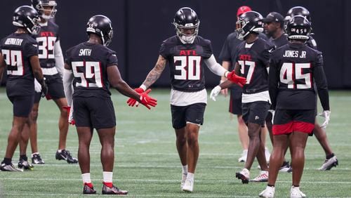 Falcons safety Jessie Bates III (30) greets teammates during a break in minicamp at Mercedes-Benz Stadium, Tuesday, June 13, 2023, in Atlanta. (Jason Getz / Jason.Getz@ajc.com)