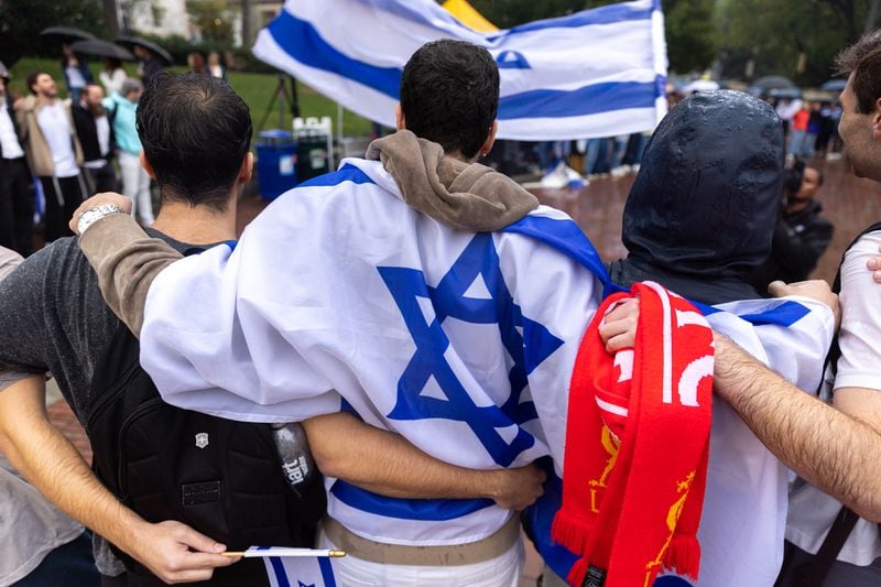 Attendees embrace and sing Jewish songs after a vigil for Israel at Emory University in Atlanta on Wednesday, October 11, 2023. The vigil was four days after Hamas militants waged a surprise attack on Israel. (Arvin Temkar/AJC)