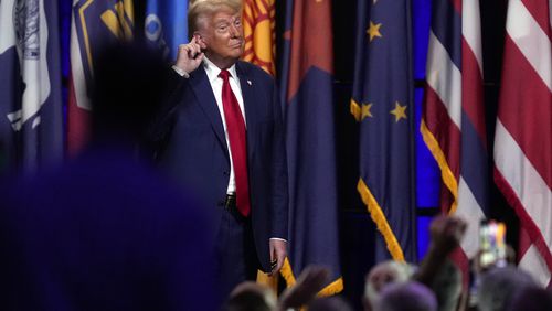 Republican presidential nominee former President Donald Trump puts his hand to his ear after speaking at the National Guard Association of the United States' 146th General Conference, Monday, Aug. 26, 2024, in Detroit. (AP Photo/Paul Sancya)