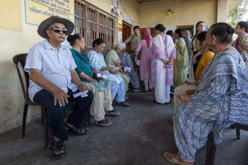 Elderly voters sit outside a polling booth waiting for their turn to vote in the seventh and last round of polling in India's national election in Dharamshala, India, Saturday, June 1, 2024. (AP Photo/Ashwini Bhatia)