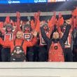 Mike Woods Jr. (front left in black overalls), known as Little Mike, and his brother Trent Woods (front right in red overalls) join the University of Georgia paint line to cheer on the Bulldogs in their game against Auburn on Oct. 8, 2022 at Sanford Stadium in Athens. The Woods brothers have been keeping alive the family tradition of painting one's bald head with the UGA logo. Trent Woods died in February 2024. (Photo courtesy of Mike Woods)