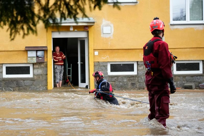 FILE - A resident waits to be evacuated from his flooded house in Jesenik, Czech Republic, Sept. 15, 2024. (AP Photo/Petr David Josek, File)