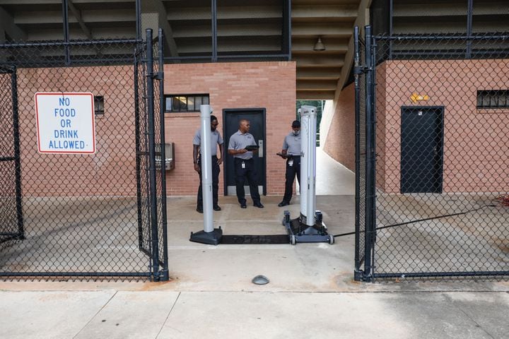 Analysts with the DeKalb County Safe Schools program perform a test run on the Evolv weapons detection system at Adams Stadium on Thursday, Aug. 15, 2024. The system has already been implemented in many DeKalb schools and will be expanding to football stadiums. (Natrice Miller/ AJC)