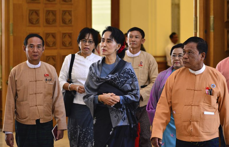 FILE - Zaw Myint Maung, right, an imprisoned politician and a close colleague of Myanmar’s ousted leader Aung San Suu Kyi, center, walks with her and Win Myint, left, who was then selected as speaker for the lower house, during a regular session of Parliament on Jan. 28, 2016, in Naypyitaw, Myanmar. (AP Photo/Aung Shine Oo, File)