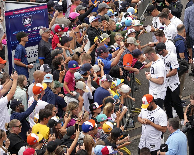 Members of the Detroit Tigers sign autographs for fans as they arrive for a visit to the Little League World Series tournament in South Williamsport, Pa., Sunday, Aug. 18, 2024. The Tigers will be playing the New York Yankees in the Little League Classic at Bowman Stadium in Williamsport, Pa., on Sunday Night Baseball. (AP Photo/Gene J. Puskar)