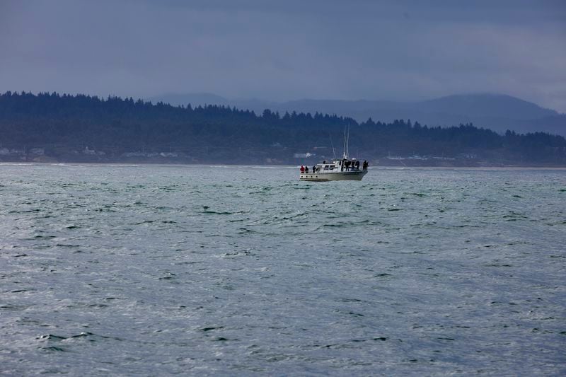 Fishermen fish in the Pacific Ocean near the wave energy test site in Newport, Ore., Friday, Aug. 23, 2024, where private developers will be able to test devices that they've designed to harness energy from waves. (AP Photo/Craig Mitchelldyer)