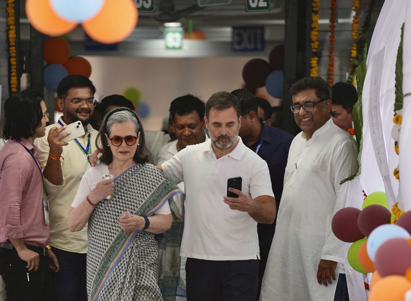 Congress leader Rahul Gandhi puts his arm around his mother and senior leader Sonia Gandhi as they leave a polling booth after casting their vote in the sixth round of polling in India's national election in New Delhi, India, Saturday, May 25, 2024. (AP Photo/Manish Swarup)