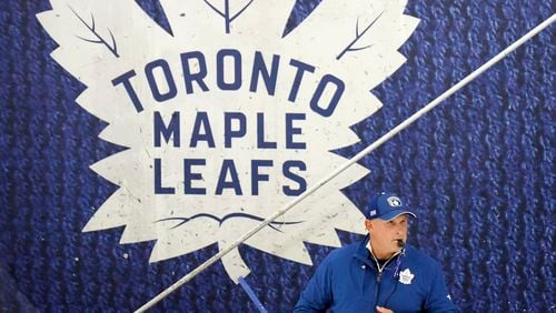 Toronto Maple Leafs new head coach Craig Berube runs his team's drills during NHL training camp in Toronto, Thursday, Sept. 19, 2024. (Nathan Denette/The Canadian Press via AP)