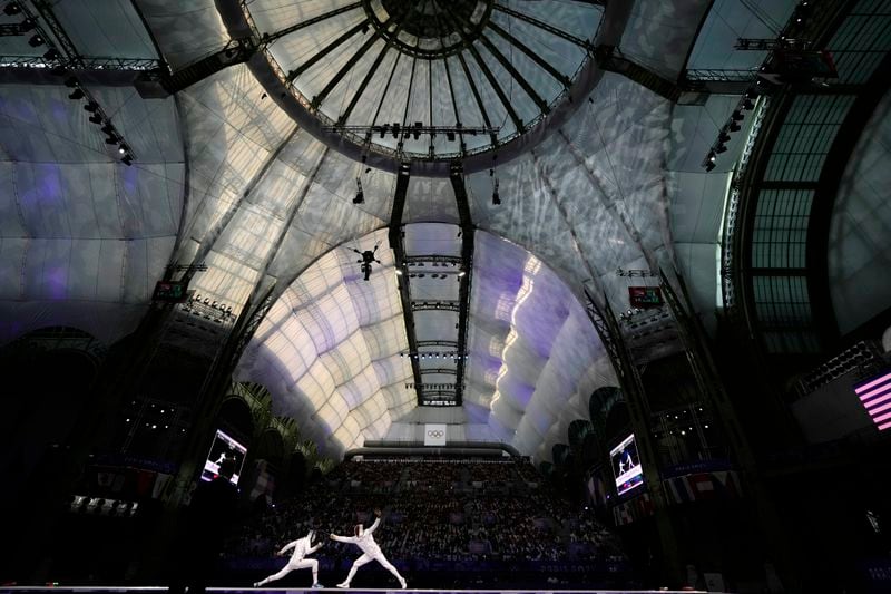 Czech Republic's Jiri Beran, left, competes with France's Yannik Borel in the men's team epee bronze final match during the 2024 Summer Olympics at the Grand Palais, Friday, Aug. 2, 2024, in Paris, France. (AP Photo/Abbie Parr)