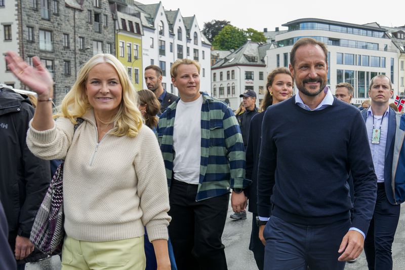 Norway's Crown Prince Haakon, Crown Princess Mette-Marit and their son Prince Sverre Magnus, center, arrive at the boats in Alesund, Norway, Friday Aug. 30, 2024, to transport them to Geiranger for the wedding celebration of Princess Martha Louise and Durek Verret on Saturday. (Heiko Junge/NTB via AP)