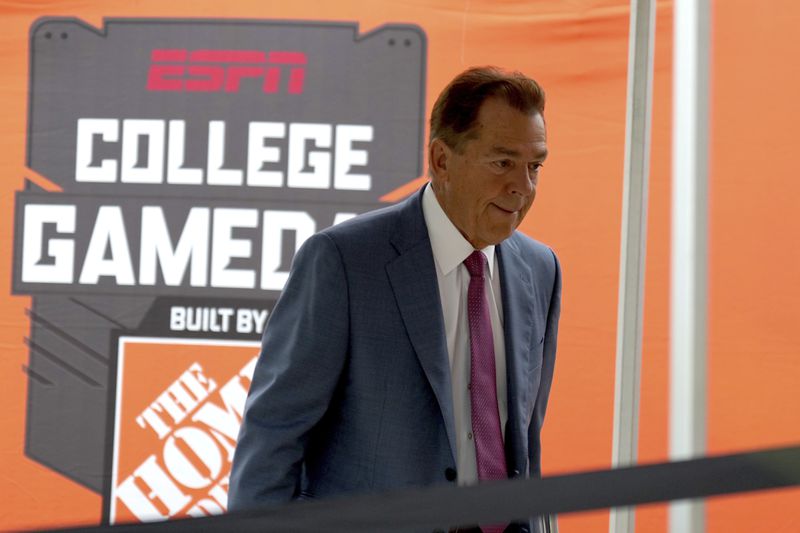 ESPN football analyst Nick Saban walks to the stage of College Game Day outside of Kyle Field on Saturday, Aug. 31, 2024, in College Station, Texas. (AP Photo/Sam Craft)