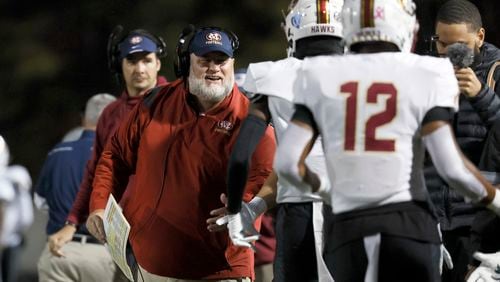 Mill Creek head coach Josh Lovelady celebrates with wide receiver Makhail Wood, behind #12, after Wood’s third touchdown reception in the first half against Milton during their Class 7A semi-final at Lakewood Stadium, Friday, December 2, 2022, in Atlanta. Jason Getz / Jason.Getz@ajc.com)
