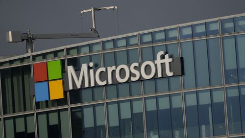 FILE - The logo of Microsoft is seen outside it's French headquarters in Issy-les-Moulineaux, outside Paris, on May 13, 2024. European Union regulators accused Microsoft of “possibly abusive” practices that violate the bloc's antitrust rules by tying its Teams messaging and videoconferencing app to its widely used business software. (AP Photo/Thibault Camus, File)