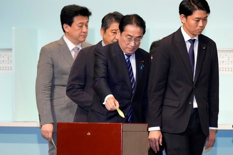 Japan's Prime Minister Fumio Kishida, center, casts his ballot at the Liberal Democratic Party's (LDP) leadership election Friday, Sept. 27, 2024, in Tokyo. (AP Photo/Hiro Komae, Pool)