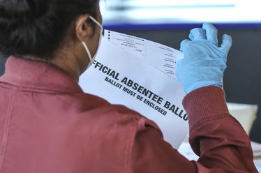 A Fulton County election worker scans absentee ballots in 2020. For the 2024 election, voters can track their ballots through the state's My Voter Page. (John Spink/AJC 2020)