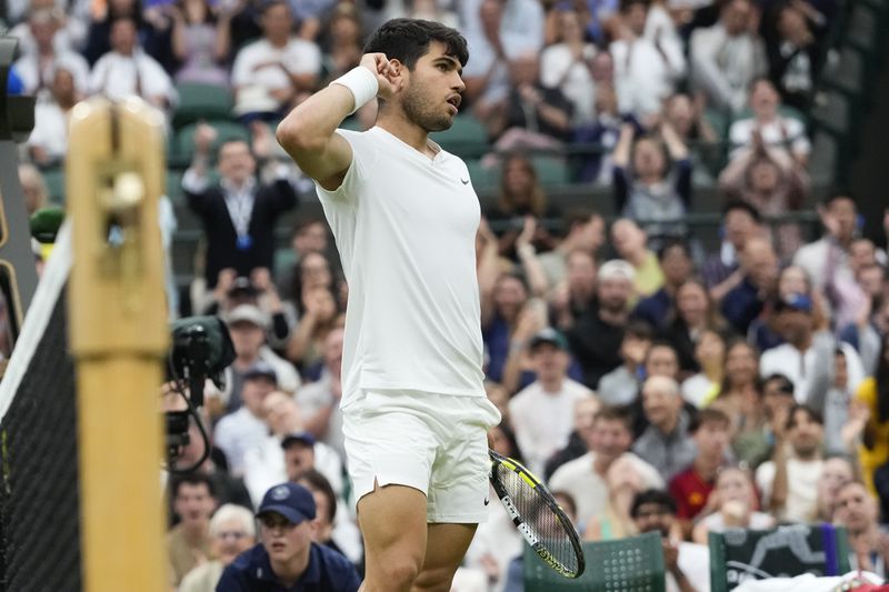 Carlos Alcaraz of Spain reacts during his quarterfinal match against Tommy Paul of the United States at the Wimbledon tennis championships in London, Tuesday, July 9, 2024. (AP Photo/Kirsty Wigglesworth)