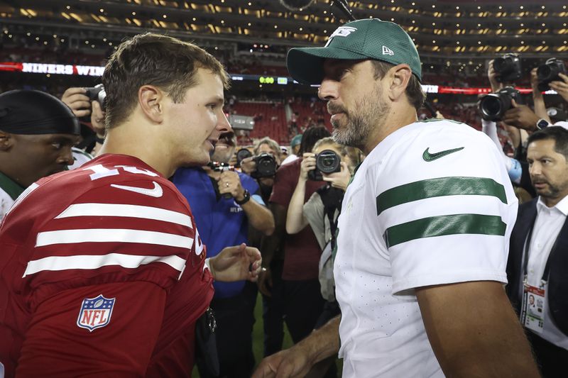 San Francisco 49ers quarterback Brock Purdy, left, talks with New York Jets quarterback Aaron Rodgers, right, after an NFL football game in Santa Clara, Calif., Monday, Sept. 9, 2024. (AP Photo/Jed Jacobsohn)