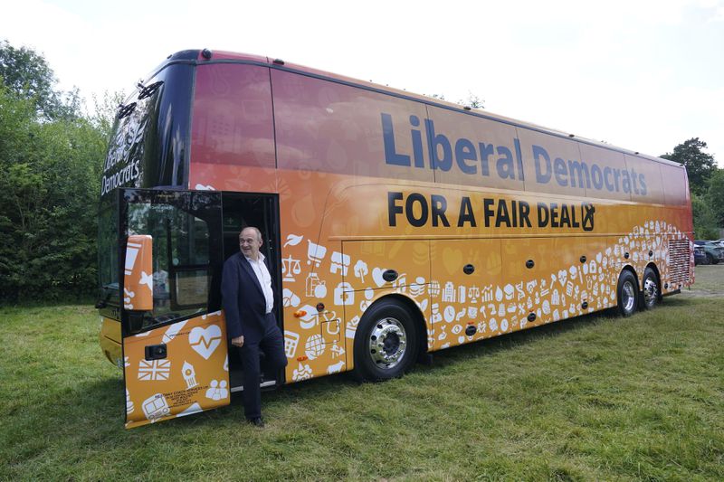 FILE - Britain's Liberal Democrat leader Sir Ed Davey arrives to visit Streatley, England, Wednesday June 26, 2024, while on the General Election campaign trail. Luxury coaches known as Battle Buses are rented by the main political parties to whisk politicians and journalists around the country for campaign visits during the five-week campaign. (Jonathan Brady/PA via AP, File)