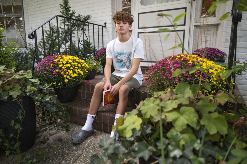 Chris Stanislawski, 14, poses for a portrait outside of his home in Garden City, N.Y., on Friday, Sept. 13, 2024. Chris didn't finish any books in his 8th grade English class, in part because their google classroom had detailed summaries of each chapter of every book. (AP Photo/Brittainy Newman)