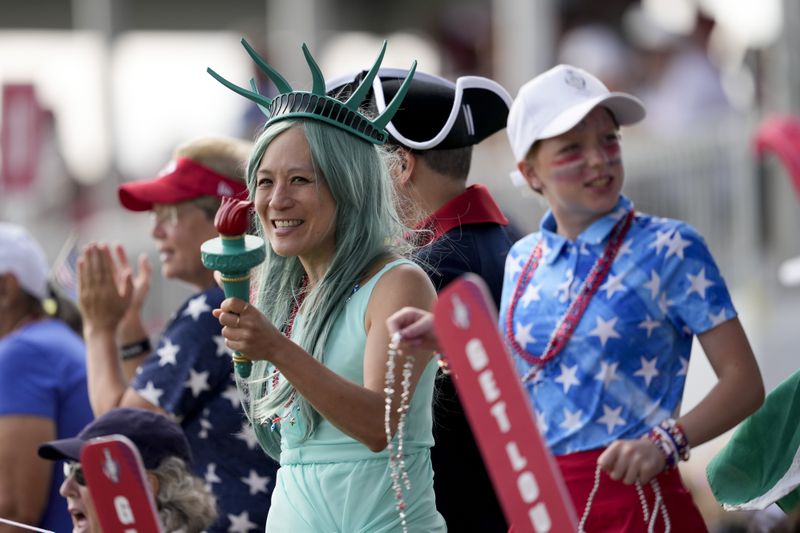 Fans watch competition along the 13th fairway during a Solheim Cup golf tournament singles match at the Robert Trent Jones Golf Club, Sunday, Sept. 15, 2024, in Gainesville, Va. (AP Photo/Matt York)