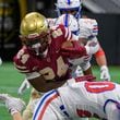 Brayden Tyson, running back for Brookwood HS, plows through Walton’s defense during the Corky Kell Classic at Mercedes Benz Stadium in Atlanta, GA on August 17, 2024. (Jamie Spaar for the Atlanta Journal Constitution)