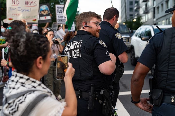 Police stand between traffic and a pro-Palestine protest near the intersection of 10th Street NW and Spring Street NW in Atlanta on Thursday, June 27, 2024. Nearby, President Joe Biden and former President Donald Trump participated in a debate hosted by CNN. (Seeger Gray / AJC)