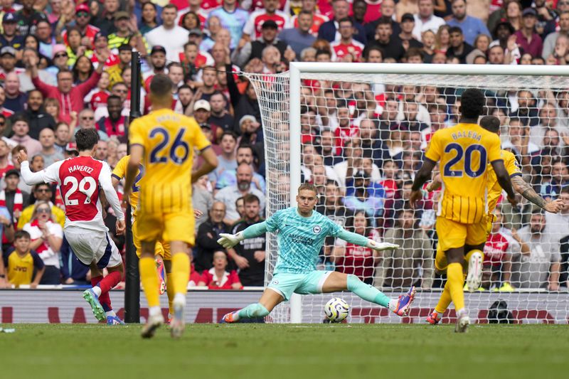 Brighton's goalkeeper Bart Verbruggen, center, makes a save in front of Arsenal's Kai Havertz, left, during the English Premier League soccer match between Arsenal and Brighton, at Emirates Stadium in London, Saturday, Aug. 31, 2024. (AP Photo/Alastair Grant)