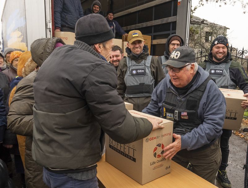 This undated photo provided by the Howard G. Buffett Foundation shows philanthropist Howard Buffett, son of Warren Buffett, distributing aid in Posad-Pokrovske, Ukraine. (Spencer Taylor/Howard G. Buffett Foundation via AP)