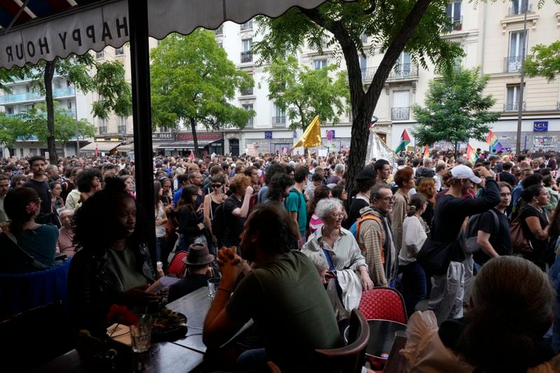 Demonstrators participate in a protest, responding to a call from the far-left party who criticized as a power grab the president's appointment of a conservative new prime minister, Michel Barnier, in Paris, France, Saturday, Sept. 7, 2024. (AP Photo/Michel Euler)