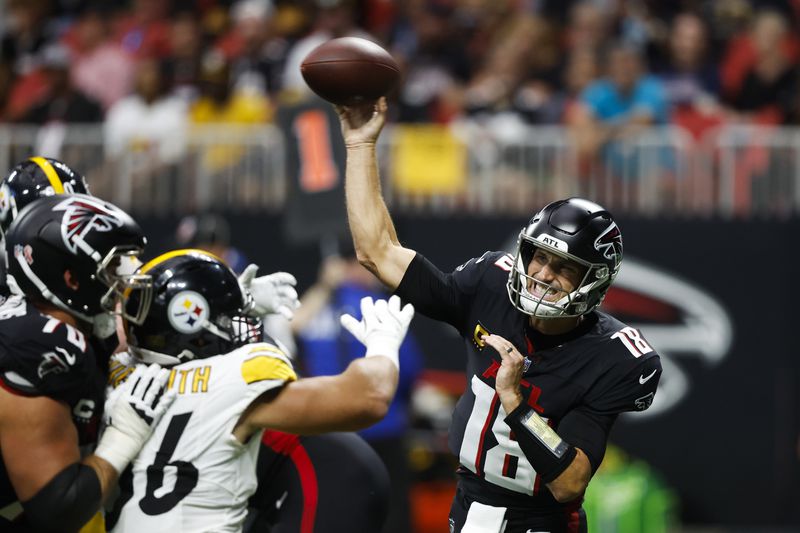 Atlanta Falcons quarterback Kirk Cousins (18) throws under pressure against the Pittsburgh Steelers during the first half of an NFL football game Sunday, Sept. 8, 2024, in Atlanta. (AP Photo/Butch Dill)