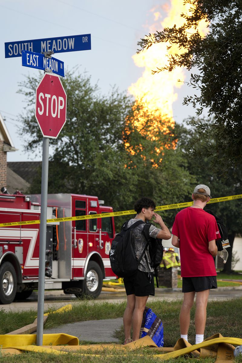 Residents watch the pipeline fire burning in La Porte, Texas, from South Meadow Drive and East Meadow Drive Monday, Sept. 16, 2024, in Deer Park, Texas. (Yi-Chin Lee/Houston Chronicle via AP)