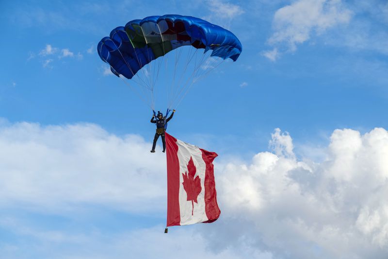A skydiver flies with a Canada flag as the Italian skydiving team puts on an exhibition for world leaders during the G7 Summit in Borgo Egnazia, Italy, on Thursday, June 13, 2024. (Sean Kilpatrick/The Canadian Press via AP)