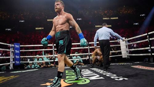 FILE - Canelo Alvarez walks away after knocking down Jaime Munguia in a super middleweight title fight, in Las Vegas, May 4, 2024. (AP Photo/John Locher, File)