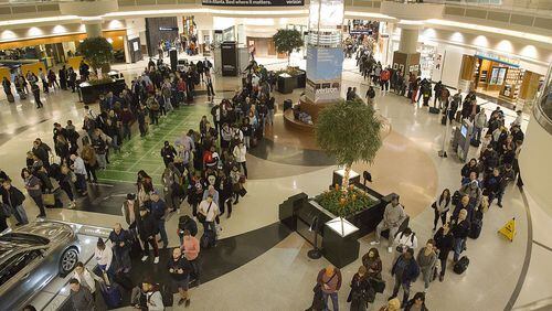 Multiple security lines at Hartsfield-Jackson International Airport ran across the atrium, then snaked through baggage claim in both domestic terminals on Monday, Feb. 4, 2019, the day after Atlanta hosted the Super Bowl.