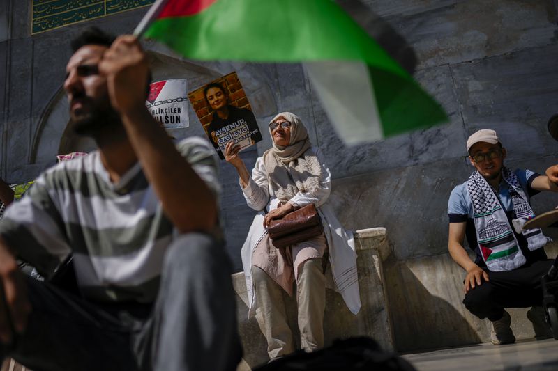 A woman holds up a photograph of Aysenur Ezgi Eygi, 26 year-old Turkish-American activist killed by the Israeli military, during a protest in her memory in Istanbul, Turkey, Saturday, Sept. 14, 2024. (AP Photo/Francisco Seco)