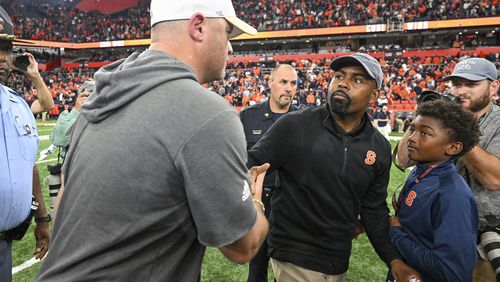 Georgia Tech coach Brent Key, left, congratulates Syracuse coach Fran Brown after a game Saturday, Sept. 7, 2024 in Syracuse, N.Y. Syracuse won 31-28. (AP Photo/Hans Pennink)