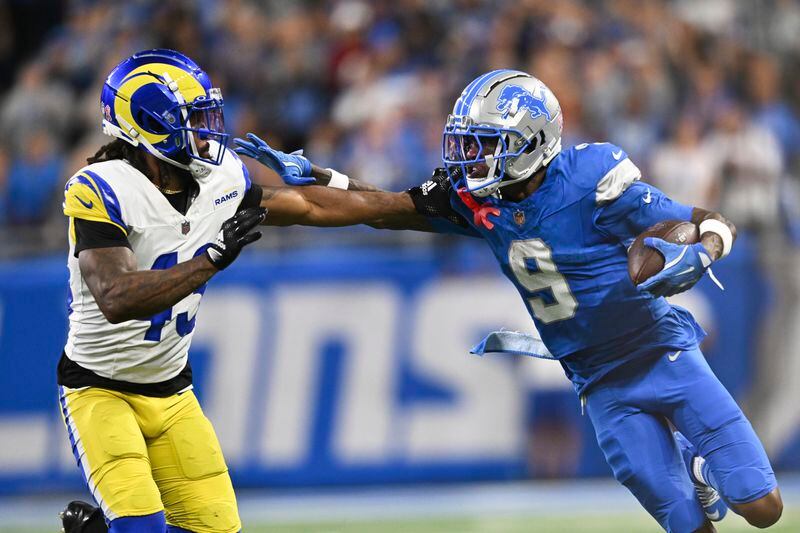 Detroit Lions wide receiver Jameson Williams (9) stiff-arms Los Angeles Rams safety John Johnson III (43) during the first half of an NFL football game in Detroit, Sunday, Sept. 8, 2024. (AP Photo/David Dermer)