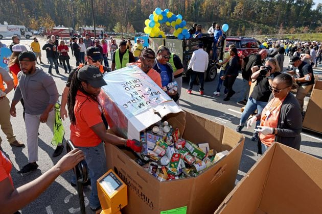 Food donations are collected fat the Nov. 4, 2022, Food-A-Thon event at the Atlanta Community Food Bank in East Point. (Jason Getz/The Atlanta Journal-Constitution)