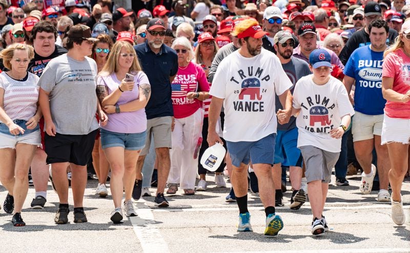 Supporters of former President Donald Trump head to his rally in Atlanta on Saturday.