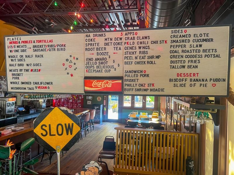 The decor at Gene's in Atlanta's East Lake neighborhood includes Christmas lights hanging from the ceiling and a vintage menu board. / Courtesy of Gene's