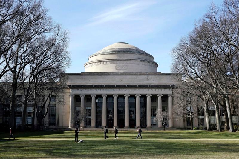 FILE - Students walk past the "Great Dome" atop Building 10 on the Massachusetts Institute of Technology campus in Cambridge, Mass, April 3, 2017. (AP Photo/Charles Krupa, File)