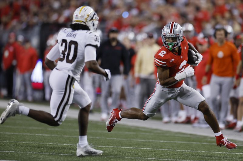 Ohio State receiver Emeka Egbuka, right, runs against Western Michigan defensive back Armani-Eli Adams, left, after a catch during the first half of an NCAA college football game Saturday, Sept. 7, 2024, in Columbus, Ohio. (AP Photo/Jay LaPrete)